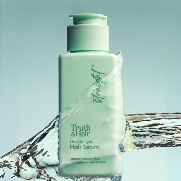 Truth & Hair straight hair serum green bottle shown emerging from a water splash on a light blue background