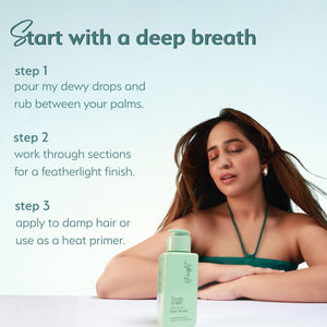 A woman with straight hair rests her arms on a surface with Truth & Hair Hair Serum bottle placed in front