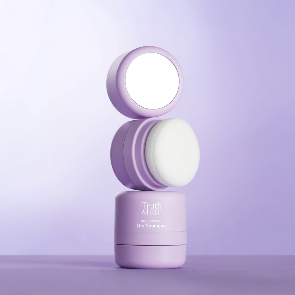 Stacked lavender compact of Truth & Hair My Powerpuff Dry Shampoo showing the mirror cap, puff applicator and product base on purple.